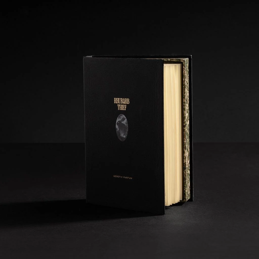 Luxury book-style perfume packaging with foil stamped spine